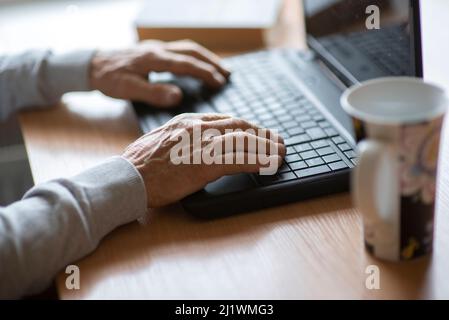 old man senior hands on laptop keyboard Stock Photo