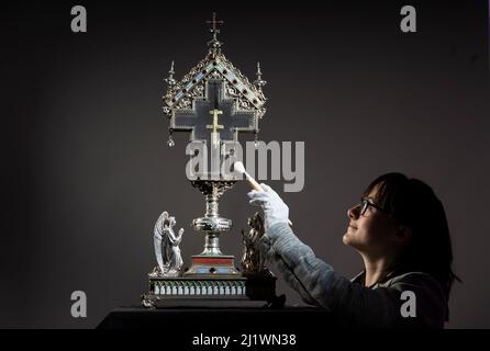 Special collections manager Dr Hannah Thomas cleans a True Cross relic at The Bar Convent Living Heritage Centre in York, as the convent marks Easter with the discovery of previously unseen authentication and provenance documents. Picture date: Monday March 28, 2022. Stock Photo