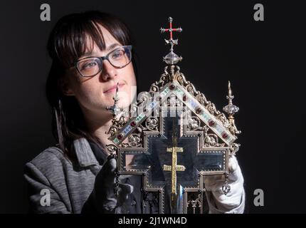 Special collections manager Dr Hannah Thomas with a True Cross relic, displayed in an ornate reliquary case made of silver gilt, precious stones and crystal, at The Bar Convent Living Heritage Centre in York, as the convent marks Easter with the discovery of previously unseen authentication and provenance documents. Picture date: Monday March 28, 2022. Stock Photo