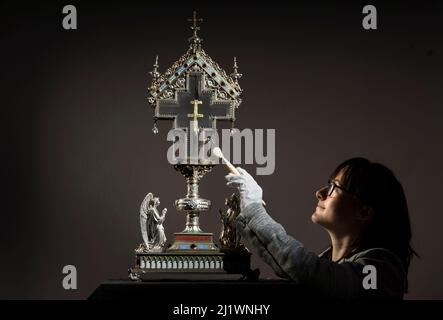 Special collections manager Dr Hannah Thomas cleans a True Cross relic at The Bar Convent Living Heritage Centre in York, as the convent marks Easter with the discovery of previously unseen authentication and provenance documents. Picture date: Monday March 28, 2022. Stock Photo