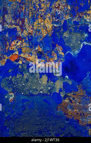 Old blue indigo painted wall with craked texture and several layers of different colors Stock Photo
