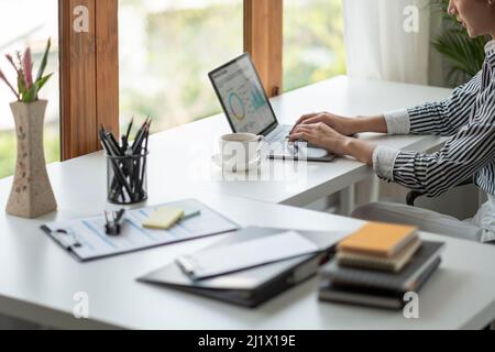 Portrait of young asian woman working with laptop at home office Stock Photo