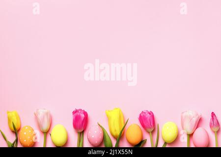 Easter composition tulips and eggs on pink background Stock Photo