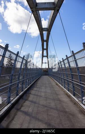 Pedestrian bridge across Trans Canada Highway in modern city suburbs Stock Photo