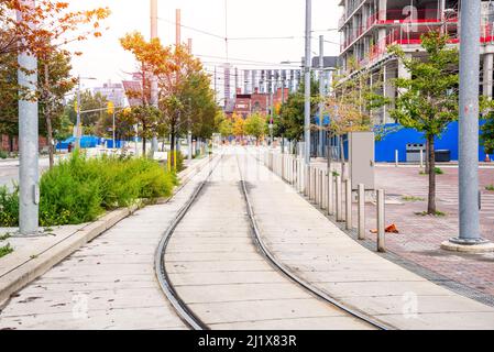 Deserted tramway along a construction site in a city centre on a cloudy autumn day Stock Photo