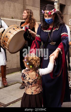 Vigo, Galicia, Spain, March 26 2022: Vertical photo of a mother teaching dancing to her daughter in a folk music festival in Galicia Stock Photo