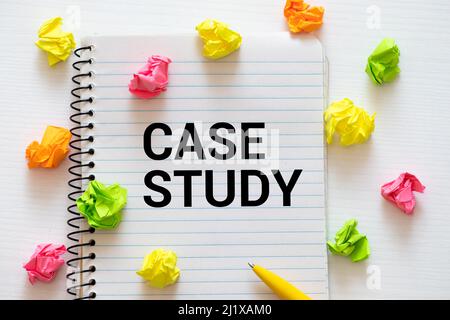 Case study memo written on a notebook with pen. Stock Photo