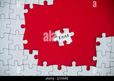 Trust text on missing jigsaw puzzle. Business concept Stock Photo