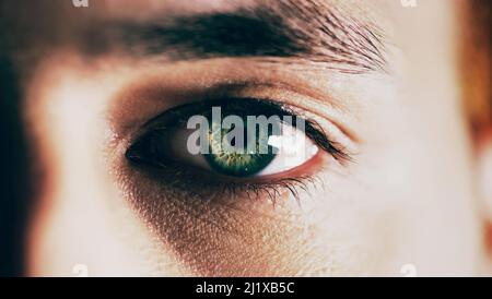 You see nature in his eyes. Closeup shot of man opening his eyes against a dark background. Stock Photo