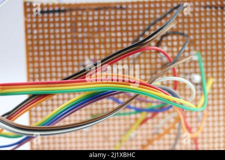 Close up view of jumper wires that makes the connection with zero printed circuit board Stock Photo