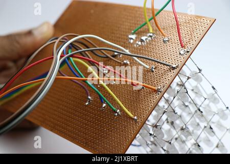 View of circuit connections that are made for a STEM project on a zero printed circuit board and light-emitting diodes Stock Photo
