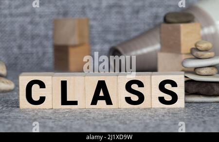 Letter block in word CLASS on wood background. Stock Photo