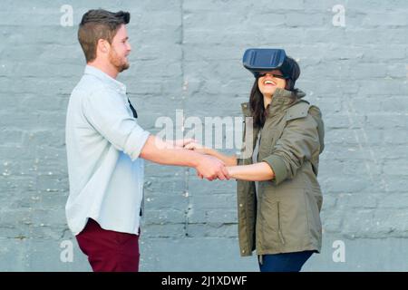 Modern technology is truly mind bobbling. Cropped shot of an affectionate young couple having fun and using a virtual reality headset together Stock Photo