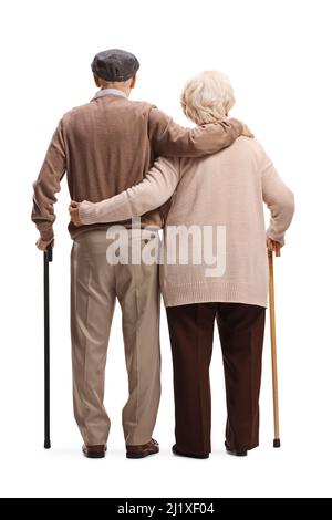 Rear view shot of a senior man and woman with walking canes in embrace isolated on white background Stock Photo