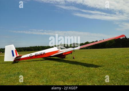 Slingsby T.61F Venture motor glider G-BUEK on the grass strip at Henham Park, Suffolk, UK. Formerly XZ559 with Royal Air Force air cadet training Stock Photo