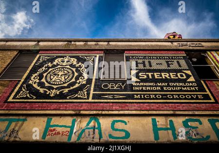 Mural by Shepard Fairey on an external building wall in Grey Eagle Street, Spitalfields. London Stock Photo