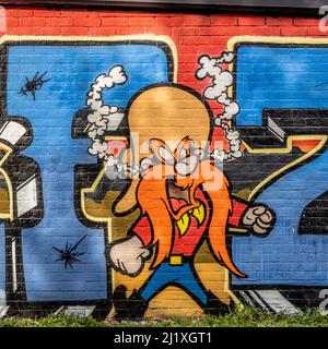 Cartoon character, Yosemite Sam graffiti on the railway wall of Station Park. Spitalfields, East London. UK. Stock Photo