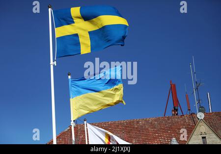 The Swedish flag and the Ukrainian flag the during Saturday in Vadstena, Sweden. Stock Photo