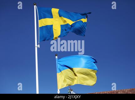 The Swedish flag and the Ukrainian flag the during Saturday in Vadstena, Sweden. Stock Photo