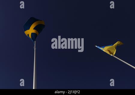 The Swedish flag and the Ukrainian flag the during Saturday in Vadstena, Sweden. Stock Photo