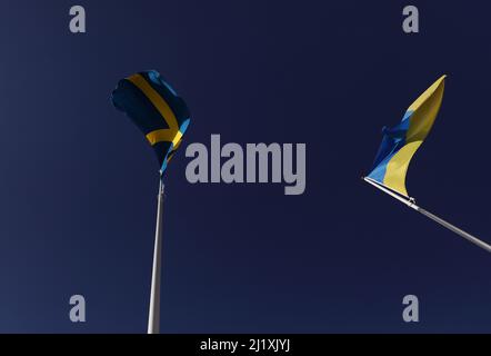 The Swedish flag and the Ukrainian flag the during Saturday in Vadstena, Sweden. Stock Photo