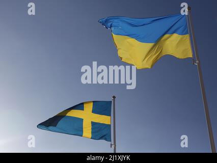 The Swedish flag and the Ukrainian flag the during Saturday in Vadstena, Sweden. Stock Photo