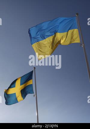 The Swedish flag and the Ukrainian flag the during Saturday in Vadstena, Sweden. Stock Photo