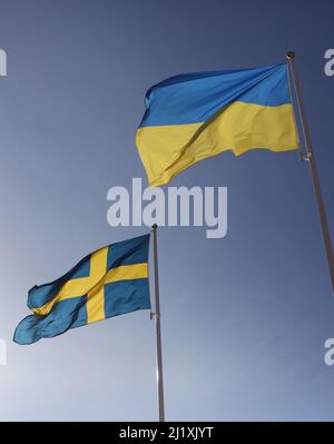 The Swedish flag and the Ukrainian flag the during Saturday in Vadstena, Sweden. Stock Photo