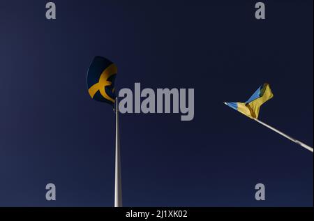 The Swedish flag and the Ukrainian flag the during Saturday in Vadstena, Sweden. Stock Photo