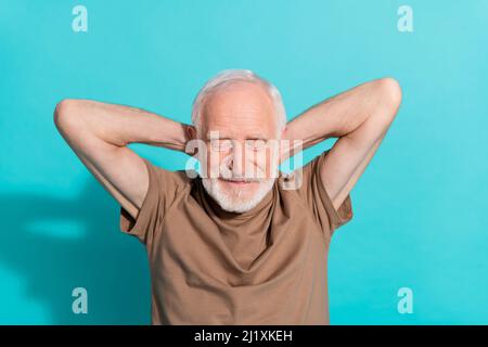 Portrait of attractive cheerful dreamy grey-haired man resting drowsing isolated over bright blue color background Stock Photo