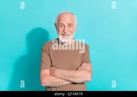 Portrait of attractive cheerful grey-haired man folded arms isolated over vibrant blue color background Stock Photo
