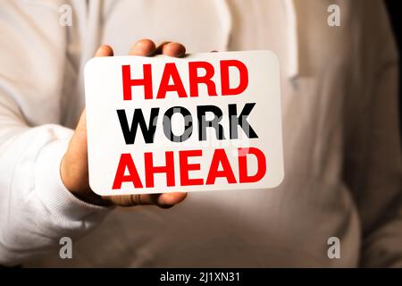 Word writing text HARD WORK AHEAD. Business concept for situation in which an employee works mainly from home Note paper taped to black computer scree Stock Photo