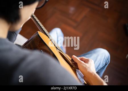 A man playing acoustic guitar Stock Photo