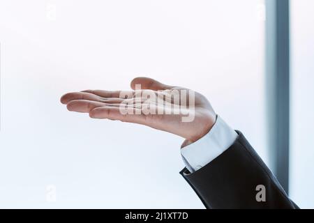 business man with a virtual object in the palm of his hand. Stock Photo