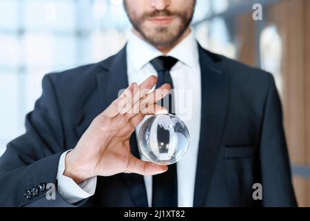 businessman showing a glass globe . close up. Stock Photo