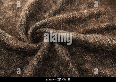 Twisted brown lambswool fabric with waves and curves. Wool material. felt texture Stock Photo