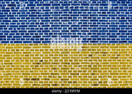 Close-up on a brick wall with the flag of Ukraine painted on it. Stock Photo