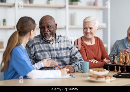Nurse having conversation with african american senior man Stock Photo