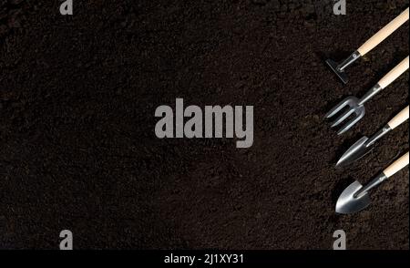 gardening tools and peat on  soil background  with copy space Stock Photo