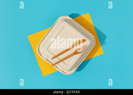 Lunchbox and cutlery on colorful table. Flat lay top view food delivery concept Stock Photo