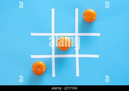 Tangerines on a blue background, flat lay, vitamins concept. Stock Photo