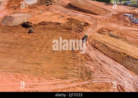 Laying of underground storm sewer pipes and sewerage well on excavator at construction in preparation process for new build Stock Photo