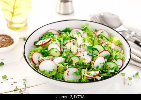 Radish and cucumber salad with lettuce and fresh green onion Stock Photo