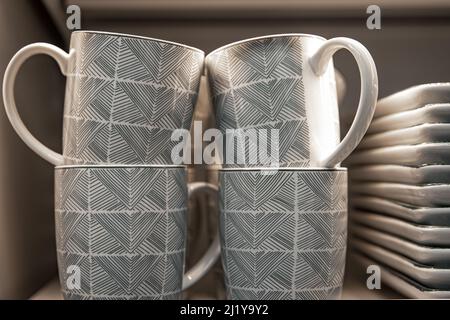 Cups on the counter of a utensil shop, close-up. Stock Photo