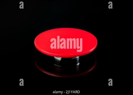 Big red button on a black background. The concept of the use of nuclear, biological or chemical weapons Stock Photo