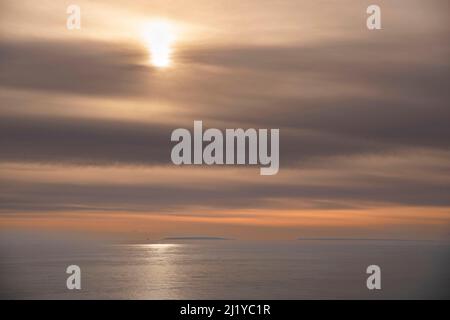 Sunset on the sea with a cloudy sky Stock Photo