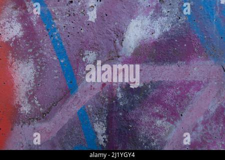 Fragment of stucco plaster wall with graffiti painting. Part of colorful street art graffiti on wall background Stock Photo