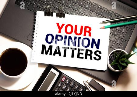 Your opinion matters text on speech bubble with businessman holding paper plane in hand on city background Stock Photo
