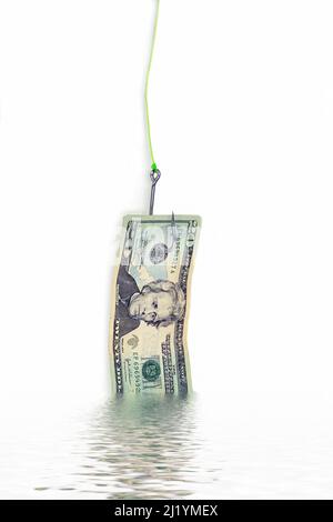 Twenty dollar bill dangling from a fish hook with water reflection on white background Stock Photo