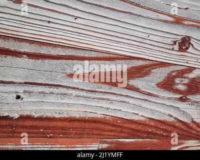 Close up of reddish-brown faded paint on weathered wood Stock Photo